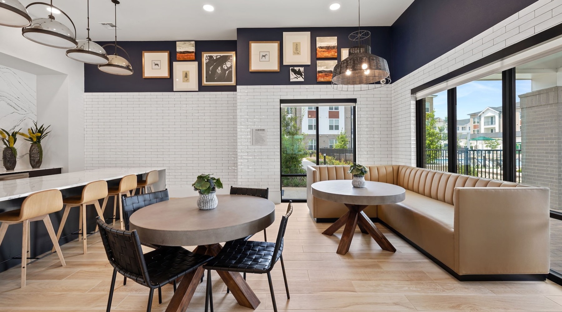 a lounge with a couch, tables and chairs