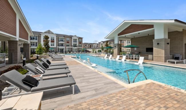 a swimming pool with a building in the background